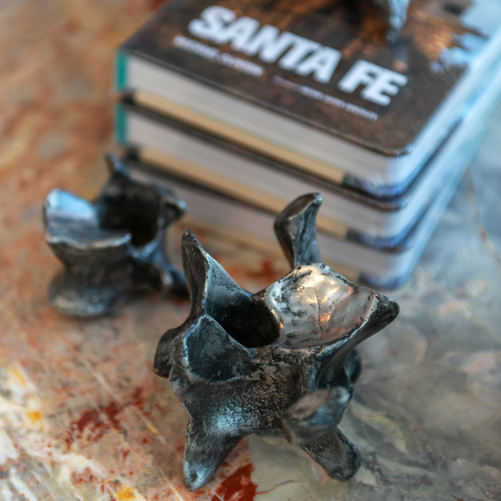 Santa Fe Books cast vertebrae candle holder marble top